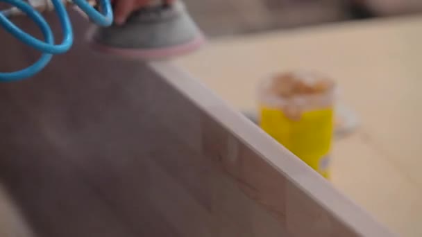 Un trabajador está lijando una pieza de madera en una fábrica de muebles. Lijado de muebles de madera. Proceso de fabricación de muebles — Vídeo de stock