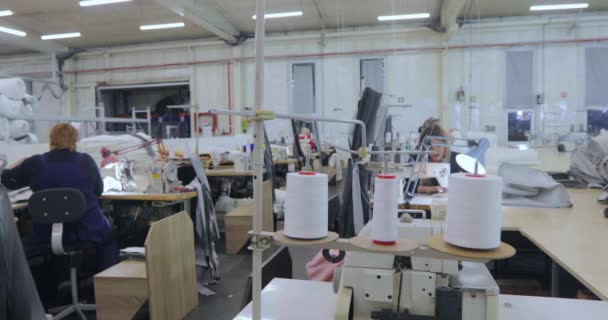 A skein of thread close-up. Spools of thread at a sewing factory. Sewing equipment at a sewing factory. — Stockvideo