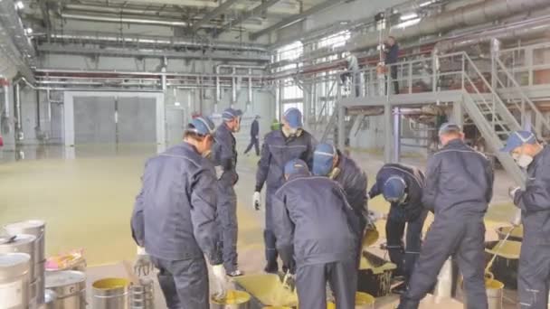 Stirring paint in a barrel, preparing material for use at a construction site. Worker stir paint in a bucket — Stock Video