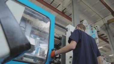 Makine operatörü kalıpla parçalar yaratıyor. Pervaz makinesinin operatörü. Endüstriyel iç