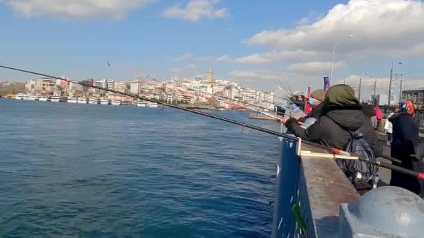 Раби ловлять рибу з моста в Стамбулі. Рибалки ловлять рибу з моста Галата. Іконічне місце в Стамбулі — стокове відео