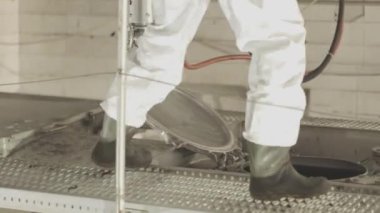 Tankerin otomatik buhar temizliği. Kimyasal koruma işçisi. Bir işçi içeriden buharlı bir tank kamyonunun kimyasal temizliğini yapar..