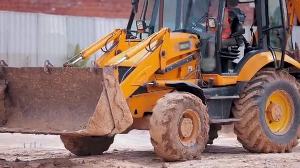 Yellow tractor on a construction site. Professional construction equipment. Work process at a construction site — Stock Video