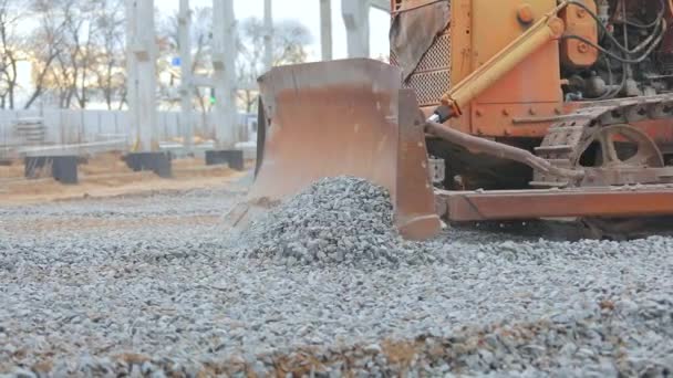 Construction machinery at the construction site. Yellow bulldozer works at a construction site. Yellow bulldozer at the construction site. — Stock Video