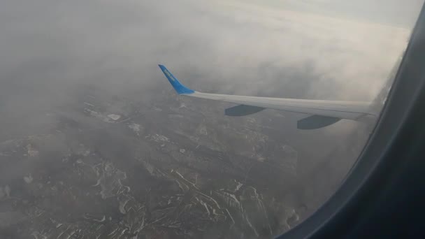 Wolken durch das Fenster eines Flugzeugs. Passagierblick durch das Flugzeugfenster. Blick aus dem Flugzeugfenster. Blick aus dem Flugzeugfenster. — Stockvideo