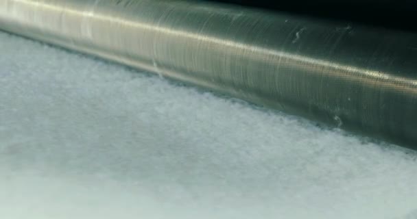 Production of synthetic winterizer close-up. Synthetic winterizer on the conveyor line, close-up. Factory for the production of non-woven materials. Syntepon manufacturing process — Stock Video