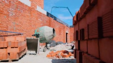 Ev inşaatında beton karıştırıcı. İnşaat alanında beton karıştırıcı. İnşaat alanında dönen beton karıştırıcı