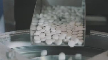 Bir sürü beyaz hap var. Yuvarlak beyaz haplar. Tablet üretim süreci yakın plan