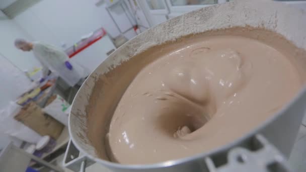 Making dough for waffles. Preparation of dough for baking waffle cups. Food production. The process of making dough in a factory — Stock Video