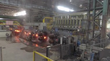 Metal kurusıkı imalatı için atölye çalışması. Endüstriyel iç mekan. Yuvarlanan metaller için konveyör hattı, yukarıdan genel bir plan. Otomatik metal yuvarlama hattı.