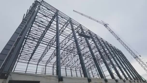 Metal frame of an industrial building. Construction of an industrial building. Construction of a large warehouse for a factory — Vídeo de stock