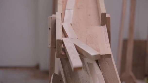 Los trabajadores arreglan bloques de madera en una fábrica de muebles. Trabajadores en la línea de transporte de una fábrica de muebles. Clasificación de espacios en blanco de madera en una fábrica de muebles — Vídeos de Stock