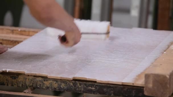 Bonding wooden parts when assembling furniture. Furniture parts are glued with glue in a furniture factory — стоковое видео