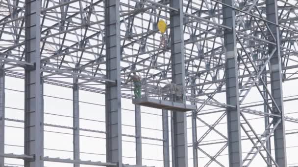 Builders paint the metal structure of the building from a pulverizer. Workers are painting metal structures. Construction work. Industrial exterior. — Stock video