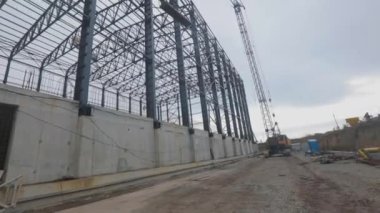 Construction of an industrial building. Metal frame of an industrial building. Construction of a large warehouse for a factory