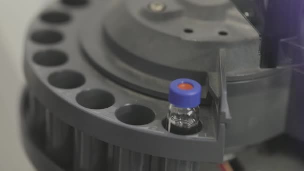 科学者はテスト管をシニトレフュージのクローズアップに挿入します。研究室のクローズアップで遠心分離機。実験室の閉鎖中の試験管 — ストック動画