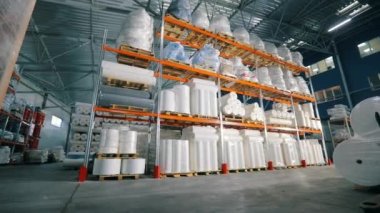 Bir sürü büyük yuvarlak boncuk. Dokumasız rulolarla dolu bir depo. Dokumasız fabrikada büyük bir depo. endüstriyel iç.