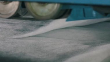 Baston olmayan malzemelerin üretimi yakın plan. Sentetik kışlık üretim fabrikası. Syntepon üretim süreci.