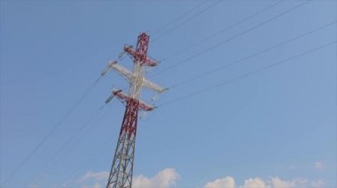 Power line against the blue sky. Modern high voltage tower. Electrical Transmission Tower against the blue sky. High Voltage Transmission Tower.