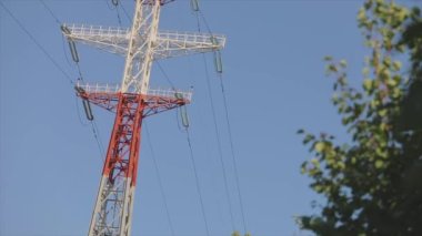 Power line against the blue sky. Modern high voltage tower. Electrical Transmission Tower against the blue sky. High Voltage Transmission Tower.