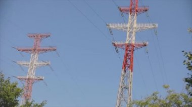 Power line against the blue sky. Modern high voltage tower. Electrical Transmission Tower against the blue sky. High Voltage Transmission Tower.
