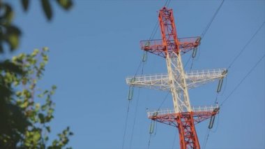 Power line against the blue sky. Modern high voltage tower. Electrical Transmission Tower against the blue sky. High Voltage Transmission Tower.