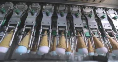Ice cream on the conveyor line. Ice cream cone on the conveyor. Automated ice cream production line.