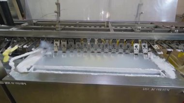 Freezing ice cream on the conveyor. Ice cream production process. Conveyor at the ice cream factory.
