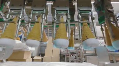 Ice cream on the conveyor line. Ice cream cone on the conveyor. Automated ice cream production line.