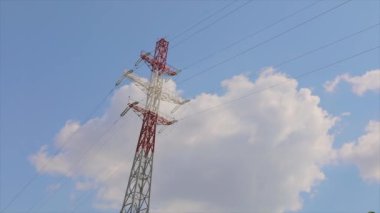 Power line against the blue sky. Modern high voltage tower. Electrical Transmission Tower against the blue sky. High Voltage Transmission Tower.