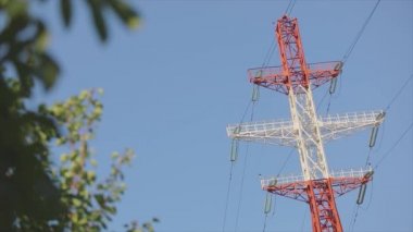 Power line against the blue sky. Modern high voltage tower. Electrical Transmission Tower against the blue sky. High Voltage Transmission Tower.