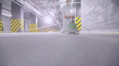 Processing a concrete floor with a grinder close-up. Grinding concrete floor large plan. Construction site equipment close-up.