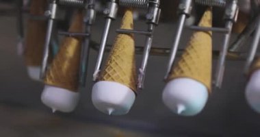 Ice cream on the conveyor line. Ice cream cone on the conveyor. Automated ice cream production line.