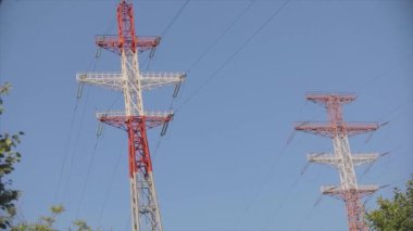 Power line against the blue sky. Modern high voltage tower. Electrical Transmission Tower against the blue sky. High Voltage Transmission Tower.