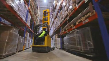 Modern forkliftte çalışan bir işçi. Büyük, modern bir depoda çalışıyorum. Modern bir depoda çalışma.