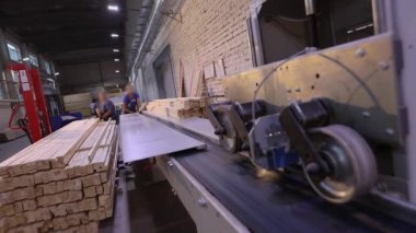 Furniture manufacture. Conveyor in a furniture factory. People work on the pavement.