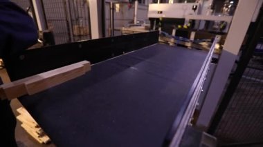 Women work in a furniture factory, workflow in a furniture factory, sorting furniture bar, a woman works with her hands in a factory.