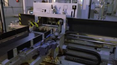 Women work in a furniture factory, workflow in a furniture factory, sorting furniture bar, a woman works with her hands in a factory.