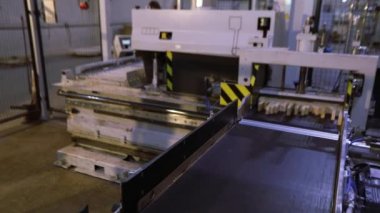 Women work in a furniture factory, workflow in a furniture factory, sorting furniture bar, a woman works with her hands in a factory.
