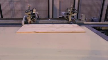 The process of furniture production, the production process of furniture panels. Mechanism close-up.