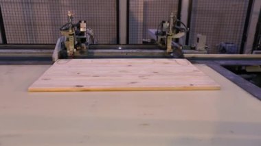 The process of furniture production, the production process of furniture panels. Mechanism close-up.