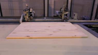 The process of furniture production, the production process of furniture panels. Mechanism close-up.