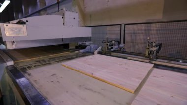 The process of furniture production, the production process of furniture panels. Mechanism close-up.