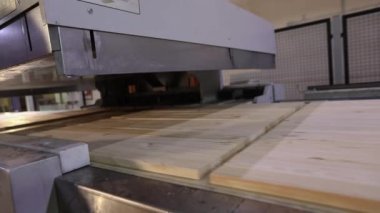 The process of furniture production, the production process of furniture panels. Mechanism close-up.
