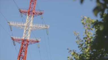 Power line against the blue sky. Modern high voltage tower. Electrical Transmission Tower against the blue sky. High Voltage Transmission Tower.