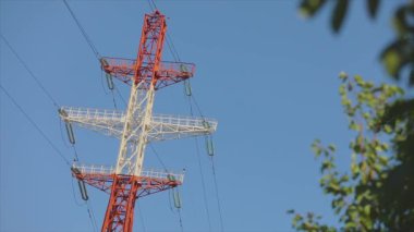 Power line against the blue sky. Modern high voltage tower. Electrical Transmission Tower against the blue sky. High Voltage Transmission Tower.