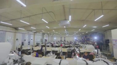 Sewing shop time lapse. Work in a large sewing shop time lapse. Many seamstresses work in the factory. Sewing factory from the inside
