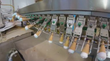 Ice cream on the conveyor line. Ice cream cone on the conveyor. Automated ice cream production line.