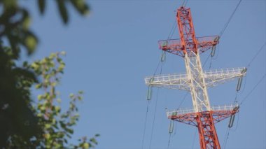 Power line against the blue sky. Modern high voltage tower. Electrical Transmission Tower against the blue sky. High Voltage Transmission Tower.