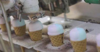 Ice cream on the conveyor line. Ice cream cone on the conveyor. Automated ice cream production line.